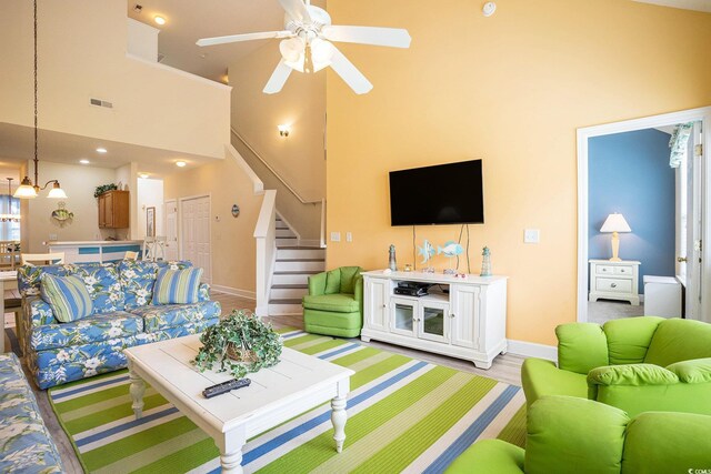6172 Catalina Dr Unit 414H, North Myrtle Beach, SC 29582 - living area with ceiling fan, stairs, and a towering ceiling