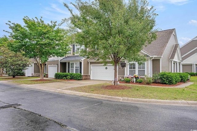 6172 Catalina Dr Unit 414H, North Myrtle Beach, SC 29582 - obstructed view of property with driveway, an attached garage, and a front lawn