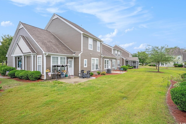 6172 Catalina Dr Unit 414H, North Myrtle Beach, SC 29582 - back of house featuring a patio, a yard, and a shingled roof