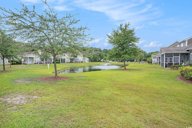 6172 Catalina Dr Unit 414H, North Myrtle Beach, SC 29582 - view of green lawn featuring a water view and a sunroom