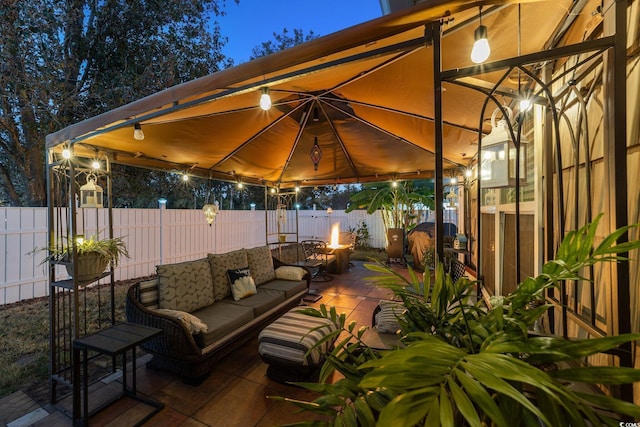200 Silverbelle Blvd, Longs, SC 29568 - patio at twilight with a gazebo, a patio area, a fenced backyard, and an outdoor living space with a fire pit