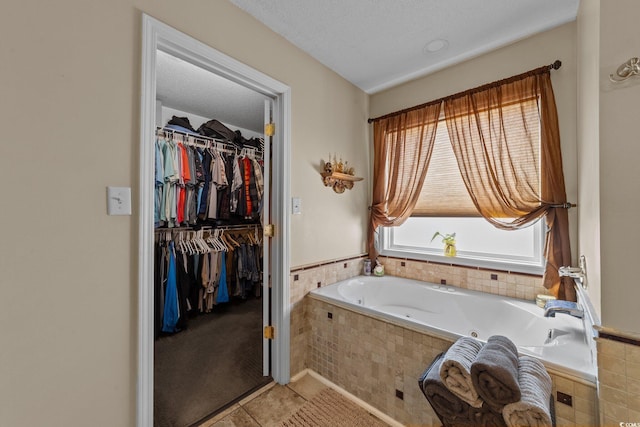 200 Silverbelle Blvd, Longs, SC 29568 - bathroom with a whirlpool tub, a walk in closet, and tile patterned flooring