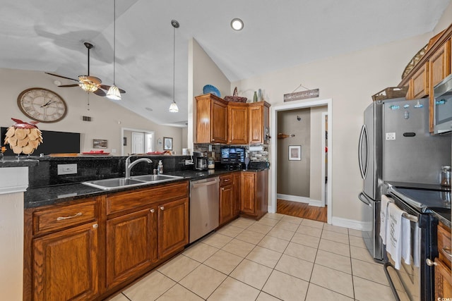 200 Silverbelle Blvd, Longs, SC 29568 - kitchen featuring stainless steel appliances, lofted ceiling, brown cabinetry, a ceiling fan, and tasteful backsplash