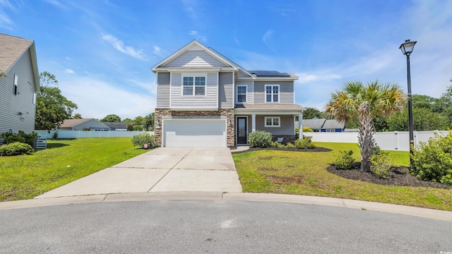 356 Ocean Commons Dr, Surfside Beach, SC 29575 - view of front facade with stone siding, roof mounted solar panels, an attached garage, and concrete driveway