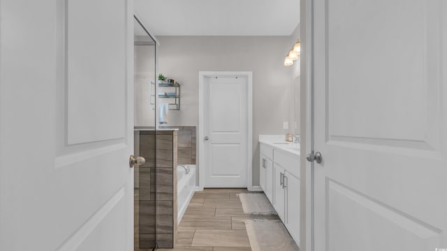 356 Ocean Commons Dr, Surfside Beach, SC 29575 - bathroom featuring vanity, a bath, and wood tiled floors