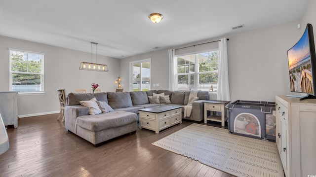 356 Ocean Commons Dr, Surfside Beach, SC 29575 - living room with plenty of natural light, a chandelier, and dark wood-style flooring