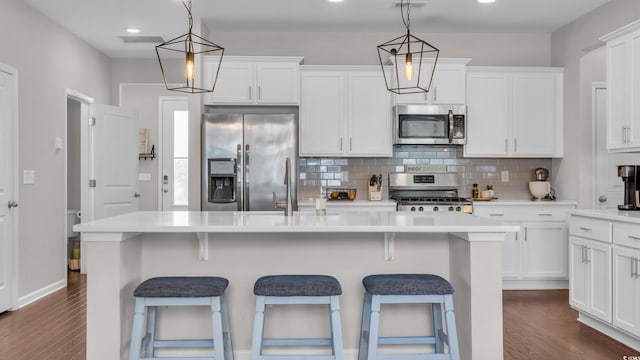 356 Ocean Commons Dr, Surfside Beach, SC 29575 - kitchen featuring appliances with stainless steel finishes, white cabinets, dark wood-type flooring, backsplash, and recessed lighting