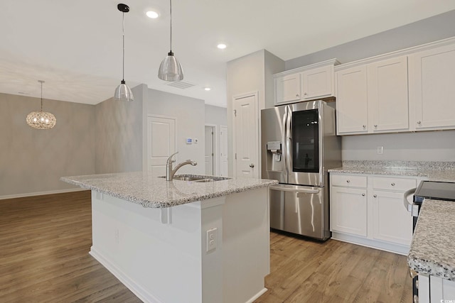 184 Sea Shell Dr Unit 12, Murrells Inlet, SC 29576 - kitchen featuring stainless steel appliances, light wood-style floors, white cabinets, an island with sink, and recessed lighting