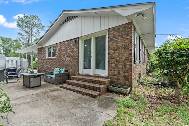 169 Ole Maple St, Loris, SC 29569 - back of property with entry steps, brick siding, a patio, and an outdoor living space