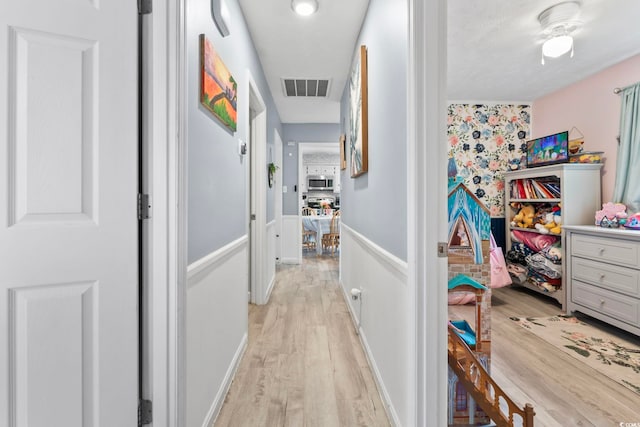169 Ole Maple St, Loris, SC 29569 - hallway with light wood-style floors and wainscoting