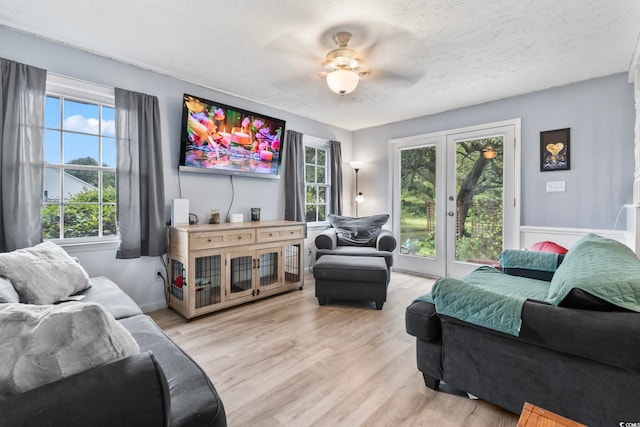 169 Ole Maple St, Loris, SC 29569 - living area with healthy amount of natural light, light wood-style floors, french doors, and a textured ceiling