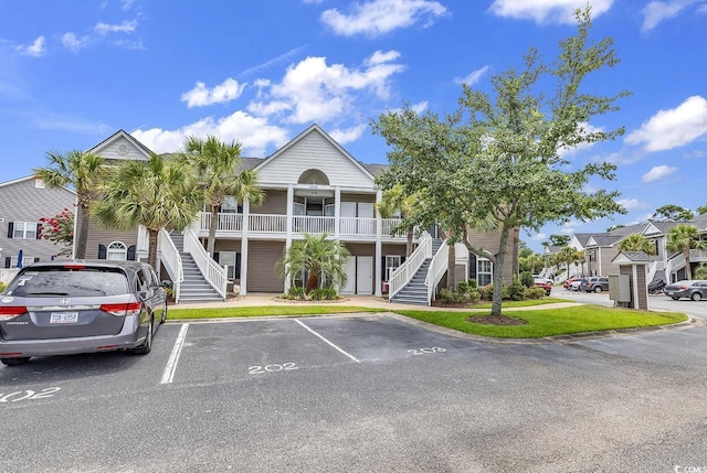 876 Palmetto Trl Unit 103, Myrtle Beach, SC 29577 - townhome / multi-family property featuring stairway, covered porch, and uncovered parking