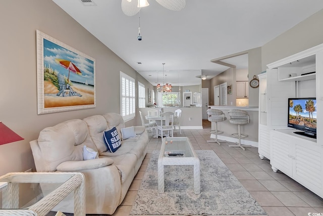 876 Palmetto Trl Unit 103, Myrtle Beach, SC 29577 - living room with light tile patterned flooring, a ceiling fan, and a chandelier