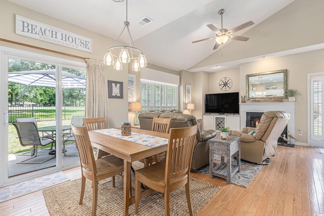 503 N 20th Ave N Unit 41D, North Myrtle Beach, SC 29582 - dining space with vaulted ceiling, light wood-style flooring, a ceiling fan, and a glass covered fireplace