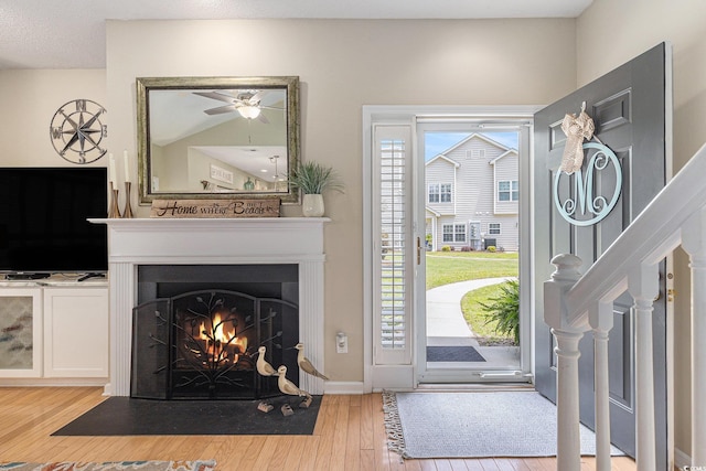 503 N 20th Ave N Unit 41D, North Myrtle Beach, SC 29582 - foyer featuring wood finished floors, a ceiling fan, a fireplace with flush hearth, and stairway