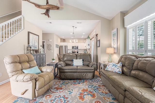 503 N 20th Ave N Unit 41D, North Myrtle Beach, SC 29582 - living area with vaulted ceiling, light wood finished floors, stairs, and a chandelier