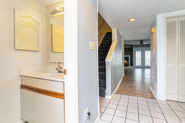 6703 Jefferson Pl Unit G5, Myrtle Beach, SC 29572 - bathroom featuring a closet, a textured ceiling, a ceiling fan, tile patterned flooring, and vanity