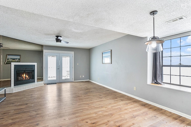 6703 Jefferson Pl Unit G5, Myrtle Beach, SC 29572 - unfurnished living room with a ceiling fan, a textured ceiling, healthy amount of natural light, and wood finished floors