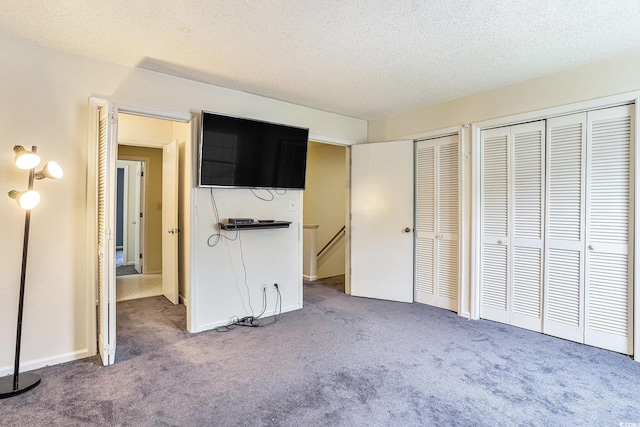 6703 Jefferson Pl Unit G5, Myrtle Beach, SC 29572 - unfurnished bedroom with carpet, multiple closets, and a textured ceiling