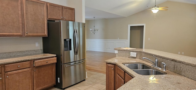 309 Outboard Dr, Murrells Inlet, SC 29576 - kitchen featuring stainless steel fridge with ice dispenser, ceiling fan, vaulted ceiling, light stone countertops, and a wainscoted wall
