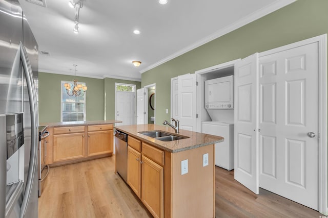 945 Rosencrans Ln Unit B, Myrtle Beach, SC 29577 - kitchen featuring stacked washer and clothes dryer, stainless steel appliances, light wood-type flooring, a chandelier, and an island with sink