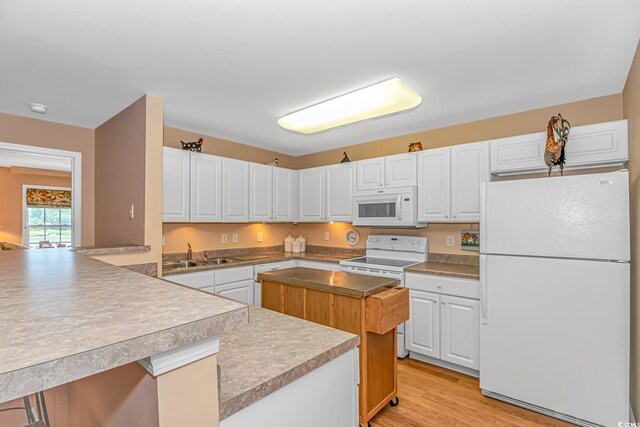 4366 Rivergate Ln Unit 306, Little River, SC 29566 - kitchen featuring white appliances, white cabinetry, a peninsula, and light wood finished floors