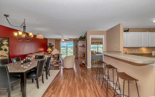 4366 Rivergate Ln Unit 306, Little River, SC 29566 - dining area with light wood-style flooring and a chandelier