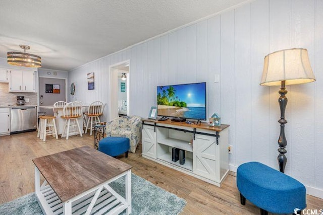4201 N Ocean Blvd Unit 2M, North Myrtle Beach, SC 29582 - living room with light wood-type flooring and a textured ceiling