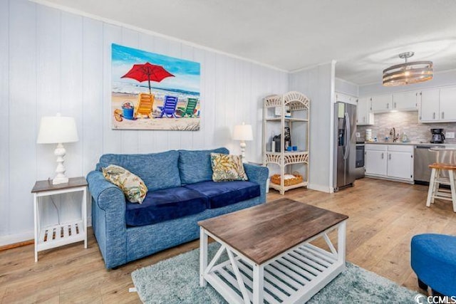 4201 N Ocean Blvd Unit 2M, North Myrtle Beach, SC 29582 - living area with light wood-type flooring and ornamental molding