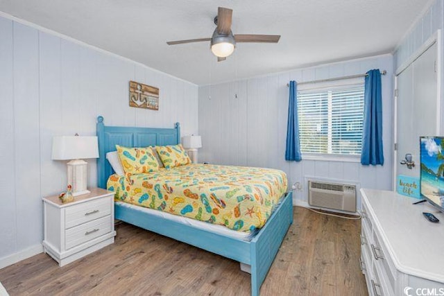 4201 N Ocean Blvd Unit 2M, North Myrtle Beach, SC 29582 - bedroom with a wall unit AC, wood finished floors, a ceiling fan, and ornamental molding