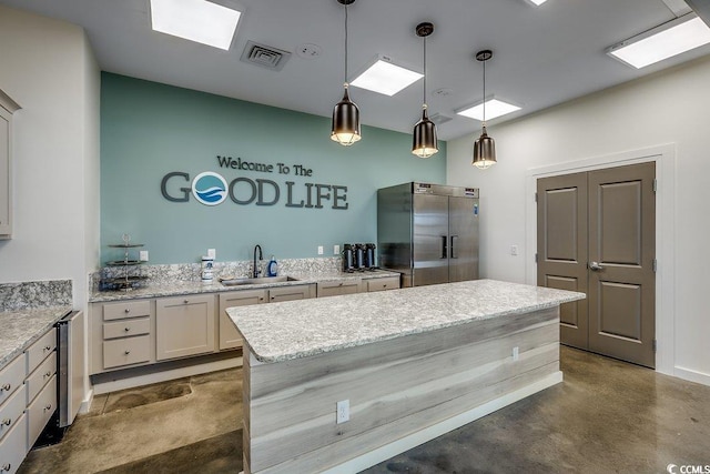 153 Goldenrod Cir Unit 7D, Little River, SC 29566 - kitchen with high end fridge, concrete flooring, a kitchen island, pendant lighting, and light stone counters