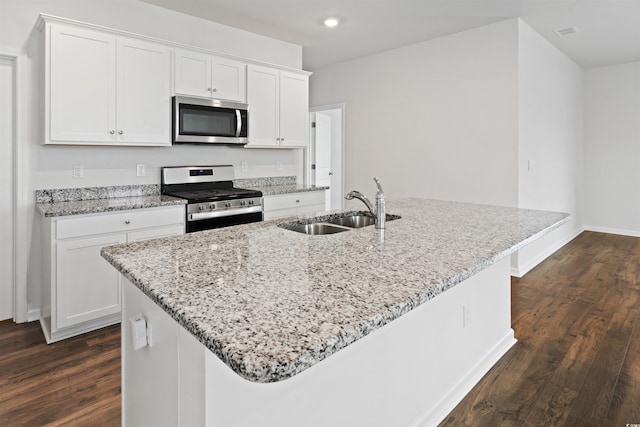 3657 Bells Lake Cir, Longs, SC 29568 - kitchen featuring stainless steel appliances, white cabinets, dark wood-type flooring, a kitchen island with sink, and recessed lighting