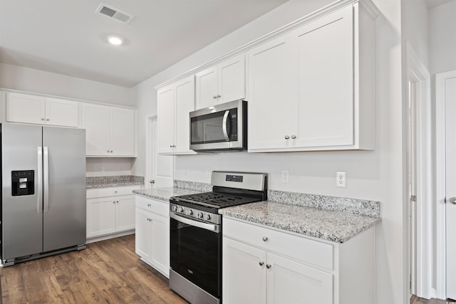 3657 Bells Lake Cir, Longs, SC 29568 - kitchen featuring appliances with stainless steel finishes, white cabinets, wood finished floors, and light stone counters