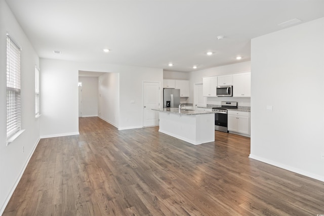 3657 Bells Lake Cir, Longs, SC 29568 - kitchen with appliances with stainless steel finishes, white cabinetry, dark wood-type flooring, a kitchen island with sink, and recessed lighting