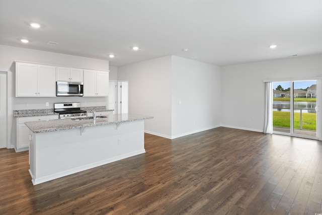 3657 Bells Lake Cir, Longs, SC 29568 - kitchen with stainless steel appliances, dark wood finished floors, a kitchen island with sink, recessed lighting, and white cabinetry