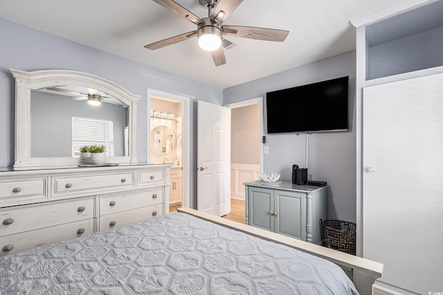 1210 N Ocean Blvd Unit 104, Surfside Beach, SC 29575 - bedroom with a ceiling fan, ensuite bath, and light wood-style flooring