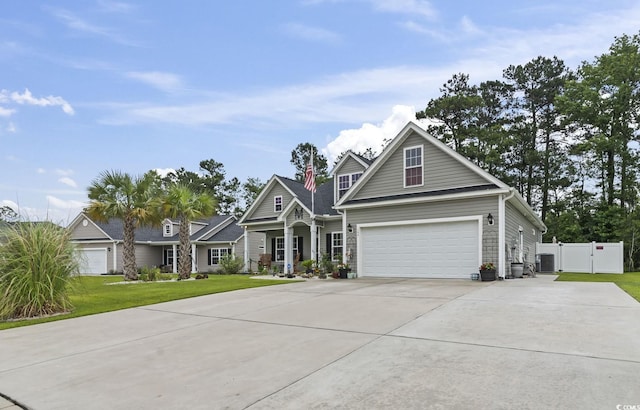 144 Baylee Cir, Aynor, SC 29544 - traditional-style house with a gate, driveway, an attached garage, and stone siding