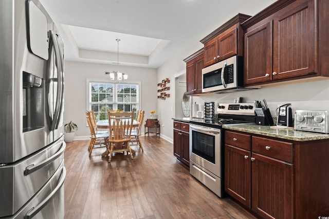144 Baylee Cir, Aynor, SC 29544 - kitchen with appliances with stainless steel finishes, a tray ceiling, a chandelier, and dark wood-type flooring