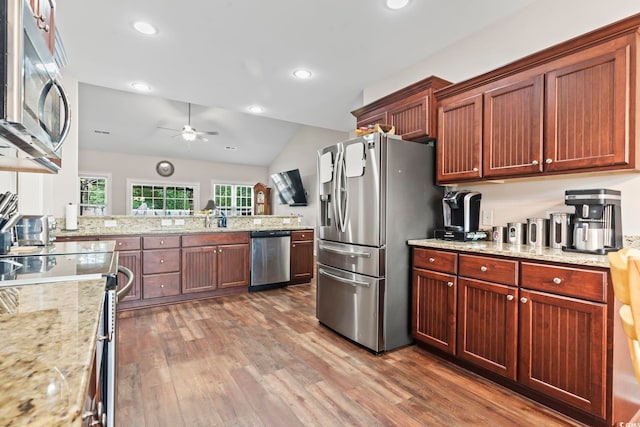 144 Baylee Cir, Aynor, SC 29544 - kitchen with appliances with stainless steel finishes, wood finished floors, a ceiling fan, lofted ceiling, and light stone counters