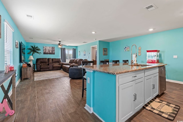 798 Woodland Farms Cir, Aynor, SC 29511 - kitchen with dishwasher, a kitchen bar, white cabinets, light stone counters, and dark wood finished floors