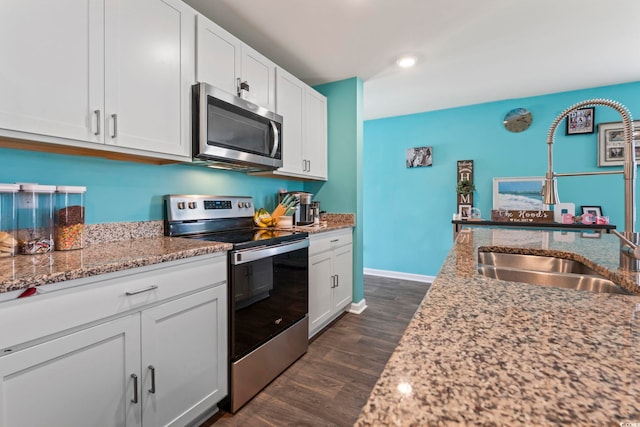 798 Woodland Farms Cir, Aynor, SC 29511 - kitchen with appliances with stainless steel finishes, light stone countertops, white cabinets, dark wood finished floors, and recessed lighting