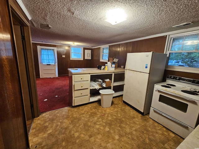 331 Dixon St, Mullins, SC 29574 - kitchen featuring white appliances, wood walls, a textured ceiling, and light countertops