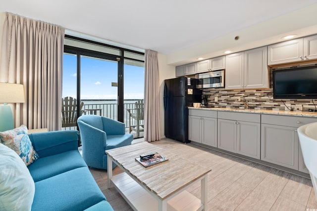 4800 S Ocean Blvd Unit 920, North Myrtle Beach, SC 29582 - living room with a wall of windows and light wood-style flooring