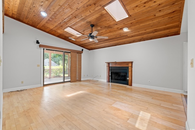 149 Old Cedar Loop, Pawleys Island, SC 29585 - unfurnished living room featuring a skylight, vaulted ceiling, wood ceiling, a fireplace, and a ceiling fan