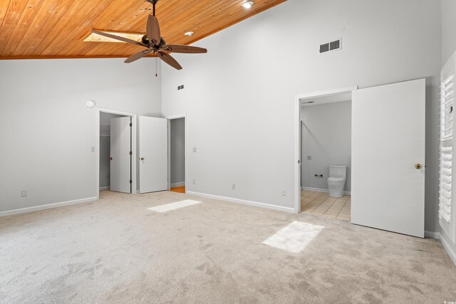 149 Old Cedar Loop, Pawleys Island, SC 29585 - unfurnished bedroom featuring wood ceiling, high vaulted ceiling, carpet, ensuite bath, and a walk in closet