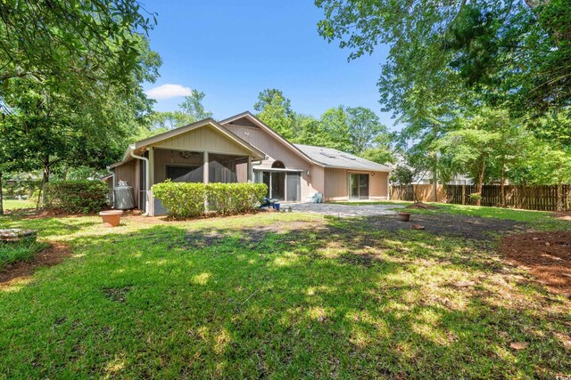 149 Old Cedar Loop, Pawleys Island, SC 29585 - rear view of house with a sunroom