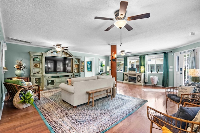 280 Morgan Ave, Little River, SC 29566 - living area with ceiling fan, a textured ceiling, a fireplace, and wood finished floors