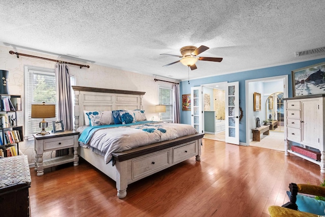 280 Morgan Ave, Little River, SC 29566 - bedroom featuring hardwood / wood-style floors, a textured ceiling, a ceiling fan, and ensuite bathroom
