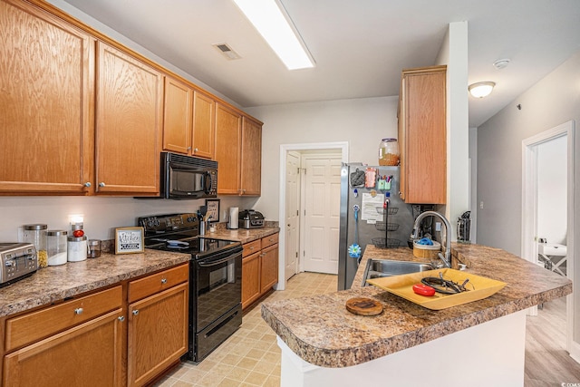2005 Silvercrest Dr Unit 32F, Myrtle Beach, SC 29579 - kitchen featuring black appliances, a peninsula, and brown cabinets