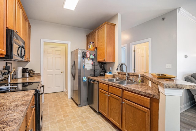 2005 Silvercrest Dr Unit 32F, Myrtle Beach, SC 29579 - kitchen featuring black appliances, a peninsula, and brown cabinetry